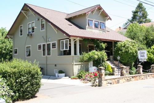 a green house with a brown roof at Eureka Street Inn in Sutter Creek