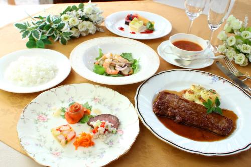 a wooden table with plates of food on it at Pension Bloom in Gujo