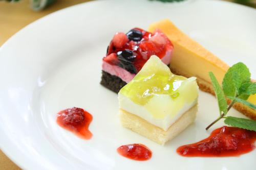 a white plate with a piece of dessert on it at Pension Bloom in Gujo