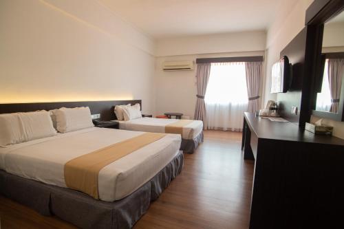 Giường trong phòng chung tại Hotel Seri Malaysia Sungai Petani