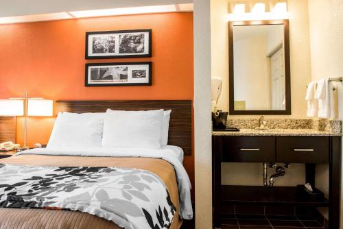 a hotel room with a bed and a sink at Quality Inn Bridgeport-Clarksburg in Bridgeport