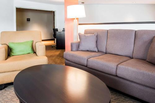 a living room with a couch and two chairs and a table at Quality Inn Bridgeport-Clarksburg in Bridgeport