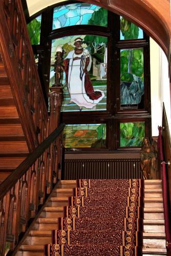 a staircase in a building with a stained glass window at Villa Vier Jahreszeiten in Crimmitschau