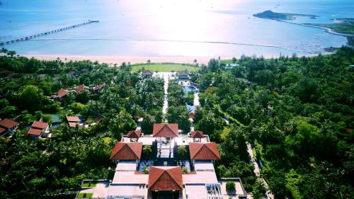 an aerial view of a building on a hill next to the ocean at Banyan Tree Sanya - Private beach, Breakfast to 2pm in Sanya