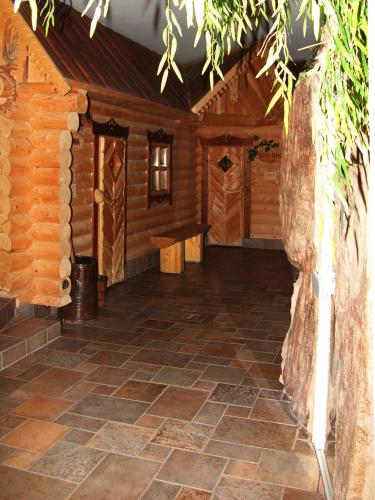 a room in a log cabin with a stone floor at Villa Vier Jahreszeiten in Crimmitschau
