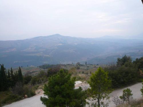 a dirt road with trees and mountains in the background at CHALET REGINA in Paradhísion