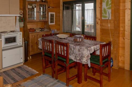 a kitchen with a table with chairs and a stove at CHALET REGINA in Paradhísion