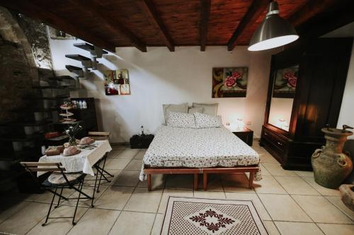 a bedroom with a bed and a table and chairs at antonella home in Brindisi
