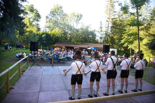a group of people standing on a stage with ropes at Hotel Gasthof Post in Nesselwang