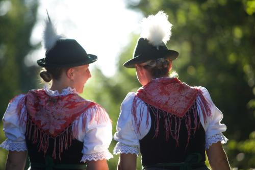 two women in traditional clothing standing next to each other at Hotel Gasthof Post in Nesselwang