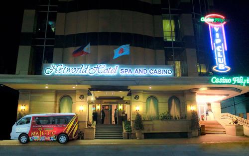 a van parked in front of a building at night at Networld Hotel Spa and Casino in Manila