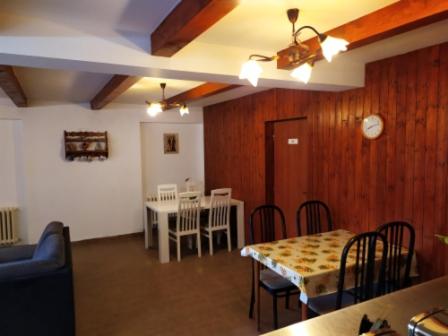 a dining room with a table and a table and chairs at Penzion Zátiší in Komorní Lhotka