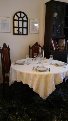 a table with plates and wine glasses on it at CHRYSSA - ΧΡΥΣΑ in Patra