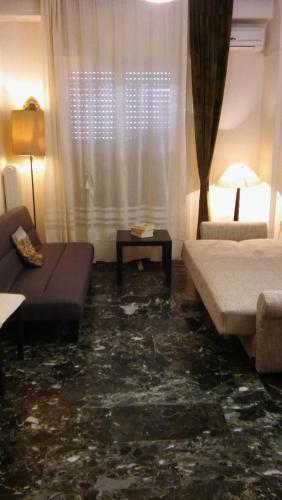 a living room with a couch and a table at CHRYSSA - ΧΡΥΣΑ in Patra