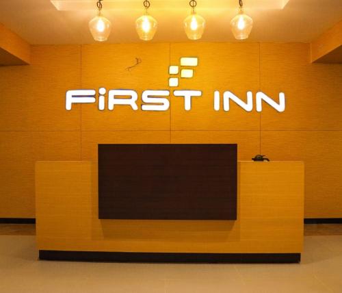 a first inn sign on the wall of a store at First Inn Hotels Chennai in Chennai