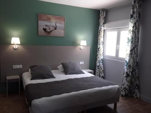 Postel nebo postele na pokoji v ubytování Hôtel Du Viaduc