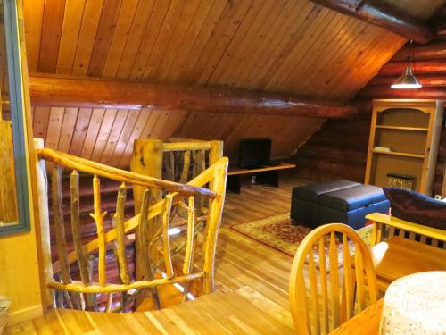 a living room with wooden floors and a wooden ceiling at Handsome Dan's at Otter Point in Sooke