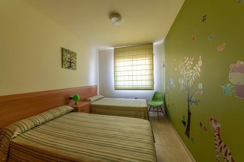 Postel nebo postele na pokoji v ubytování Golden Beach Apartamentos