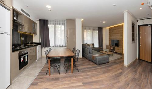 a kitchen and living room with a table and a couch at Princess Residence in Istanbul