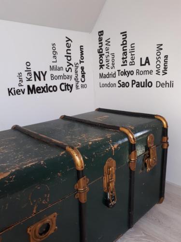 a green suitcase sitting on top of a table at La petite Juliette in Leuze-en-Hainaut