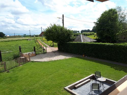 a view of a yard with a table and chairs at La petite Juliette in Leuze-en-Hainaut