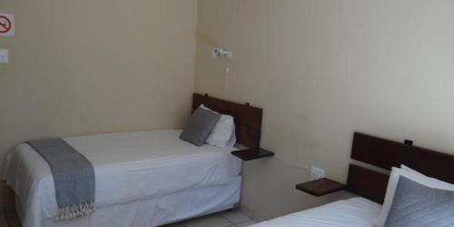 a bedroom with two beds in a room at Lepha Guest House in Onverwacht