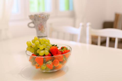 a bowl of fruit sitting on a table at Central View Apartment in Hvar