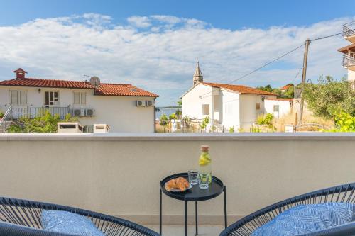 a table with a bottle of wine on a balcony at Central View Apartment in Hvar