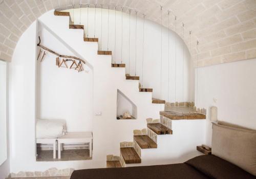 a staircase in a room with a white wall at La casa del geko in Vieste