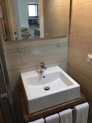 a bathroom with a white sink and a mirror at La casa del geko in Vieste
