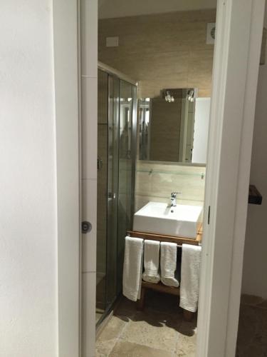 a bathroom with a sink and a mirror at La casa del geko in Vieste