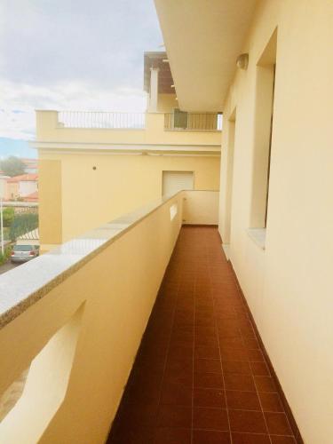 a corridor of a building with a balcony at A Due Passi in La Maddalena