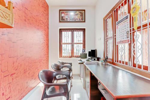 an office with a desk and chairs in a room at Redstone House by Oxystays Hospitality in Ganpatipule