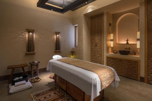 
a bedroom with a large bed and a large window at The Chedi Al Bait, Sharjah in Sharjah
