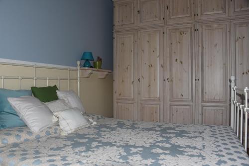 a bedroom with a bed with white pillows at Ca' Mia Ca' Tua in La Loggia