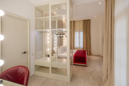 a room with a glass partition with a bed in it at LETO Boutique Hotel Zugdidi in Zugdidi