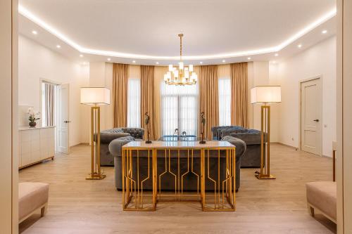 a living room with a table and chairs at LETO Boutique Hotel Zugdidi in Zugdidi