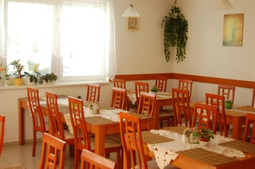 a dining room with wooden tables and chairs at Penzion Jarka in Bratislava