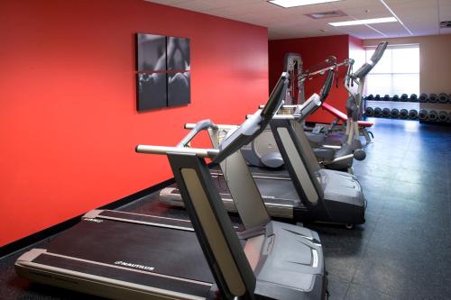 a gym with a row of tread machines in a room at Country Inn & Suites by Radisson, Knoxville at Cedar Bluff, TN in Knoxville