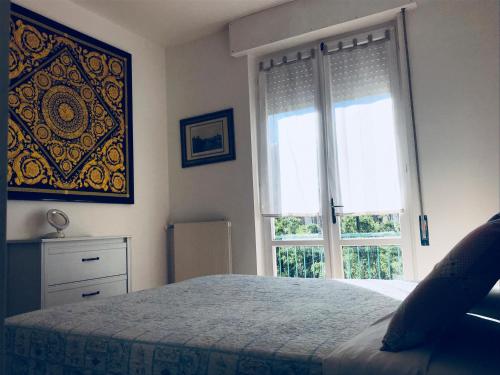 a bedroom with a bed and a large window at La casa di LULU’ in Deiva Marina