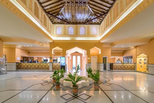 un hall d'un hôtel avec des plantes au centre dans l'établissement Hotel Saray, à Grenade