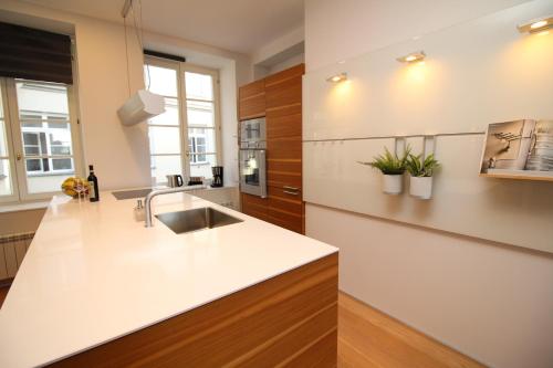 a kitchen with a white counter top and a sink at Tallinn City Apartments Old Town Square in Tallinn