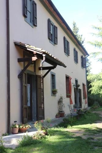 a large white building with an awning on it at Agriturismo Bethsaid in Fauglia