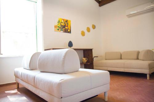 a living room with a white couch and a table at Villa Mallandrino in Mondello