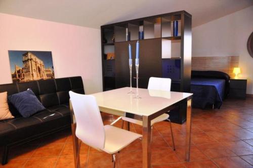 a living room with a table and a couch at Villa Smeraldo Roma in Infernetto