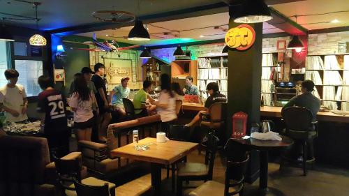 a group of people sitting in a restaurant at Gangneung Guesthouse Myu in Gangneung