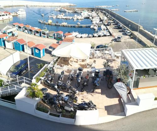 an aerial view of a marina with motorcycles parked at BUE MARINO Hotel & Roof Lounge in Cala Gonone