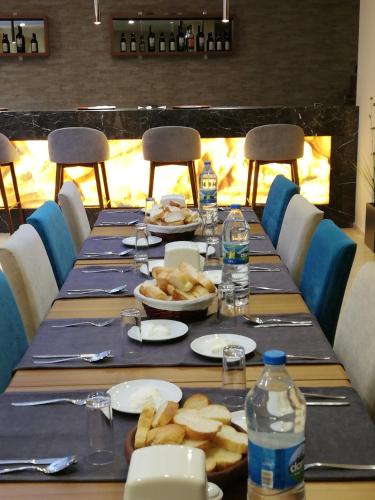 a long table with plates of food and bottles of water at Piskin Hotel in Denizli