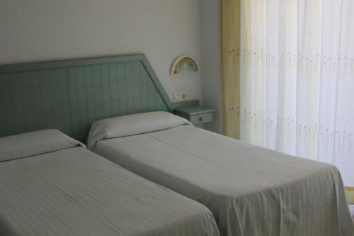 two beds sitting next to each other in a bedroom at APARTAMENTOS EL VELERO VIP in Torremolinos
