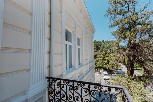 a balcony of a house with a window at Boulevard Hotel Batumi in Batumi